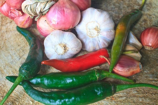 thai kitchen food spice herb pepper red onion garlic for cooking on top wood table