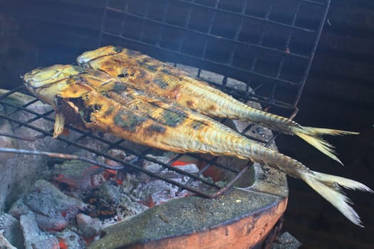 Cooking of salted fish on a grill stove