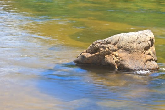 stones in river in deep forest, abstract nature background
