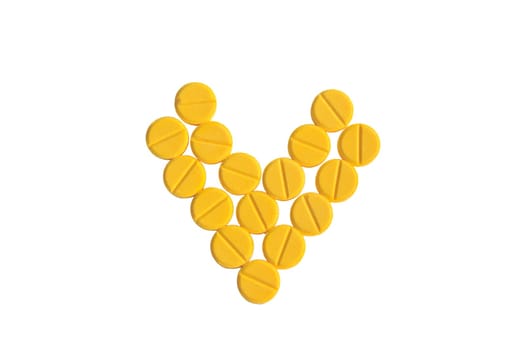 heart shaped of yellow medicine on the white background