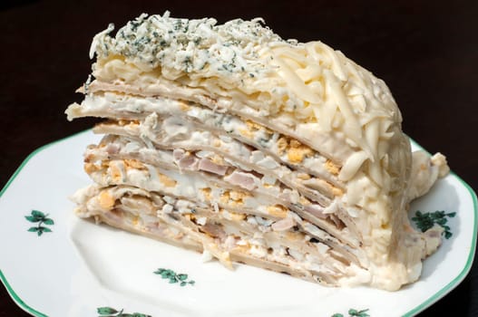 Homemade salty pancake cake piece in plate