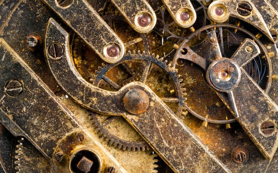 Extreme close up of the inside workings of a jeweled pocket watch time piece