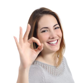 Close up of a happy woman with perfect smile gesturing ok isolated on a white background