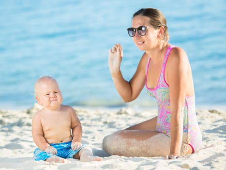 Baby and mother on the tropical beach