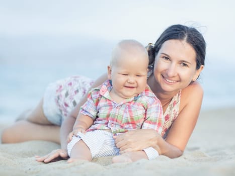 Baby and mother on the tropical beach