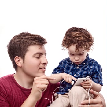 Young father teach his son to work with smartphone