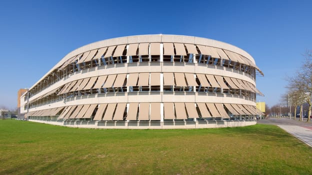 modern building with closed sunshades on a sunny day