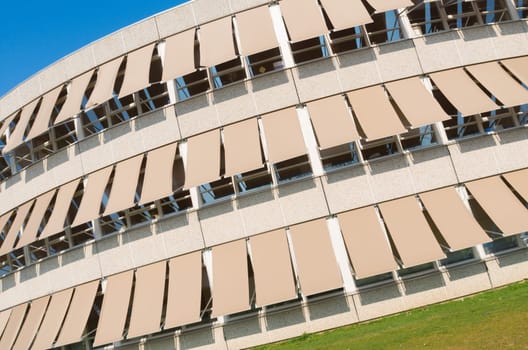 modern building with closed sunshades on a sunny day