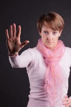 mature woman with a raised hand meaning you can't go further