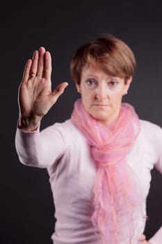 mature woman with a raised hand meaning you can't go further