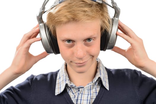 Teenage boy smiling with headphones listening to music isolated