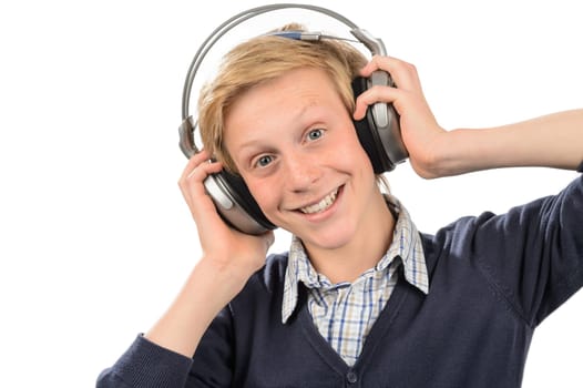 Happy teenage boy listening to music against white background