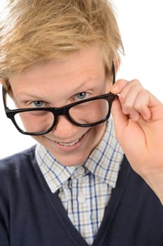 Cheerful nerd boy looking above geek glasses against white background