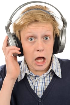 Shocked teenage boy wear headphones listening to music isolated on white