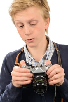 Teenage boy using retro camera against white background