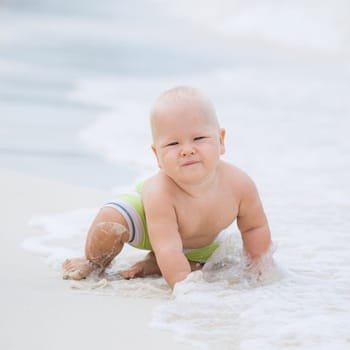 Cute baby on the tropical beach