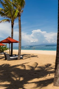 Tropical beach with sun lounger and umbrellas with white sand in the Caribbean