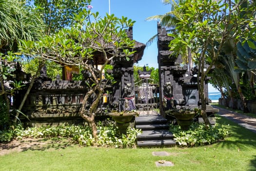 Stairs on a stone wall to an entrance to a house in Bali