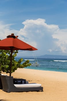 Tropical beach with sun lounger and umbrellas with white sand in the Caribbean