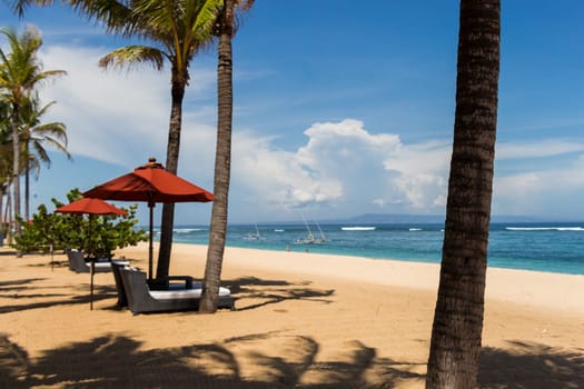 Tropical beach with sun lounger and umbrellas with white sand in the Caribbean