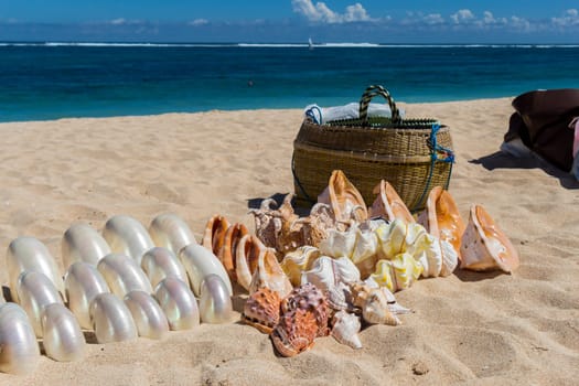 Collected mussels are put up for sale by souvenir dealers on the beach in Bali