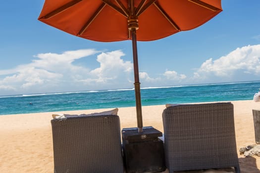 Tropical beach with sun lounger and umbrellas with white sand in the Caribbean