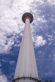 KL Towet in kuala Lumpur Malaysia from below in front of blue sky with clouds