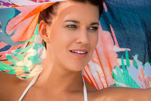 Young pretty woman with dark hair in bikini and Pareo on vacation on the beach portrait