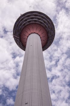 KL Towet in kuala Lumpur Malaysia from below in front of blue sky with clouds
