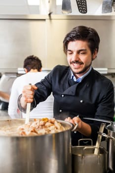 young adult chekoch in the restaurant kitchen at the herd while cooking