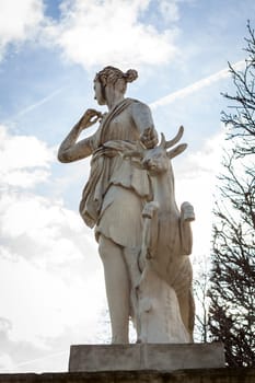 Statue of stone marble carved in front of blue sky in Paris