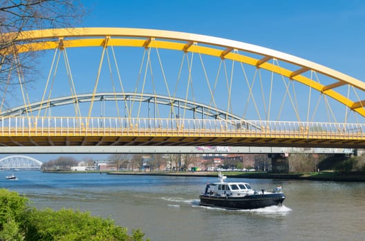 yellow arch bridge in Utrecht, netherlands. The Hogeweide Bridge is a steel arch bridge over the Amsterdam-Rhine Canal