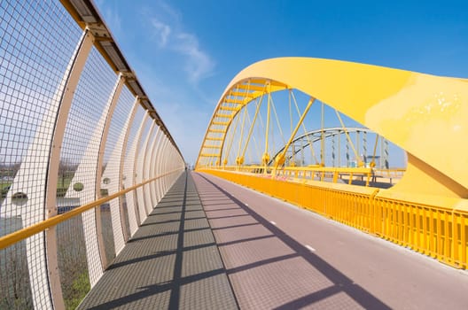 detail of the yellow arch bridge in Utrecht, netherlands. The Hogeweide Bridge is a steel arch bridge over the Amsterdam-Rhine Canal