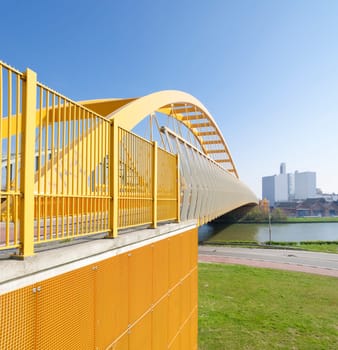 yellow arch bridge in Utrecht, netherlands. The Hogeweide Bridge is a steel arch bridge over the Amsterdam-Rhine Canal