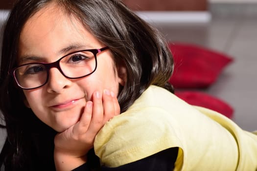 Cute brunette girl with glasses posing