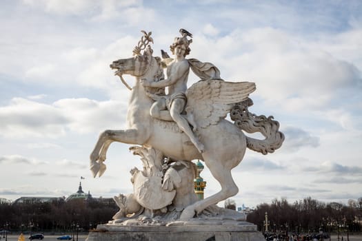 Statue of stone marble carved in front of blue sky in Paris