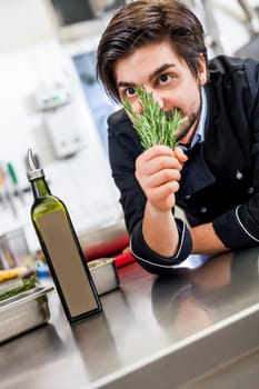 young chef in the restaurant kitchen with fresh arümatic spices
