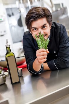 young chef in the restaurant kitchen with fresh arümatic spices