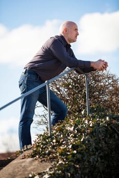 Man middle-aged senior pensioner taking a break in the outdoor park