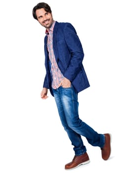 Young man in trendy casual look with dark hair and beard isolated against a white background