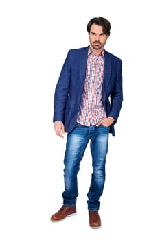 Young man in trendy casual look with dark hair and beard isolated against a white background