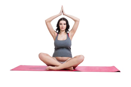 Attractive pregnant young woman makes yoga isolated against white background