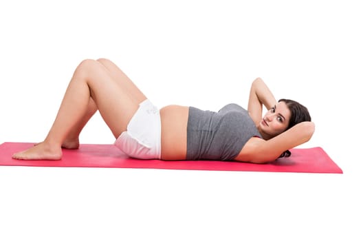 Young woman at birth preparation yoga isolated against white background