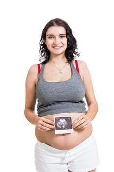 Young attractive woman with ultrasound image in hand pregnant isolated against white background