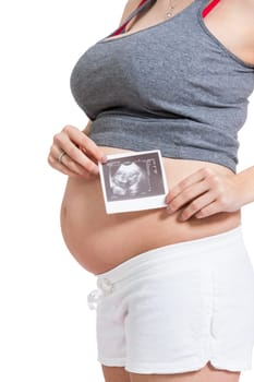 Young attractive woman with ultrasound image in hand pregnant isolated against white background