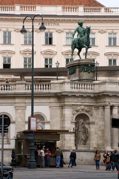 Vienna,Austria - March 31,2014: Locals and tourists stand at a sausage stall under Albrecht's equestrian monument in front of the Albertina Art Museum on March 31,2014 in Vienna.