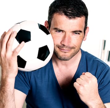 closeup of passionate soccer player with white and black balloon
