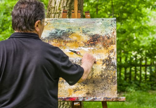 Artist paints an abstract image