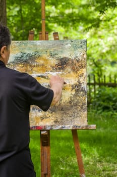 Artist paints an abstract image
