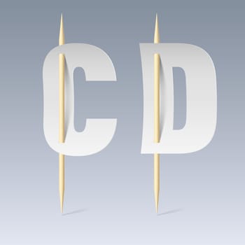 White paper cut font on toothpicks on grey background. C and D letters